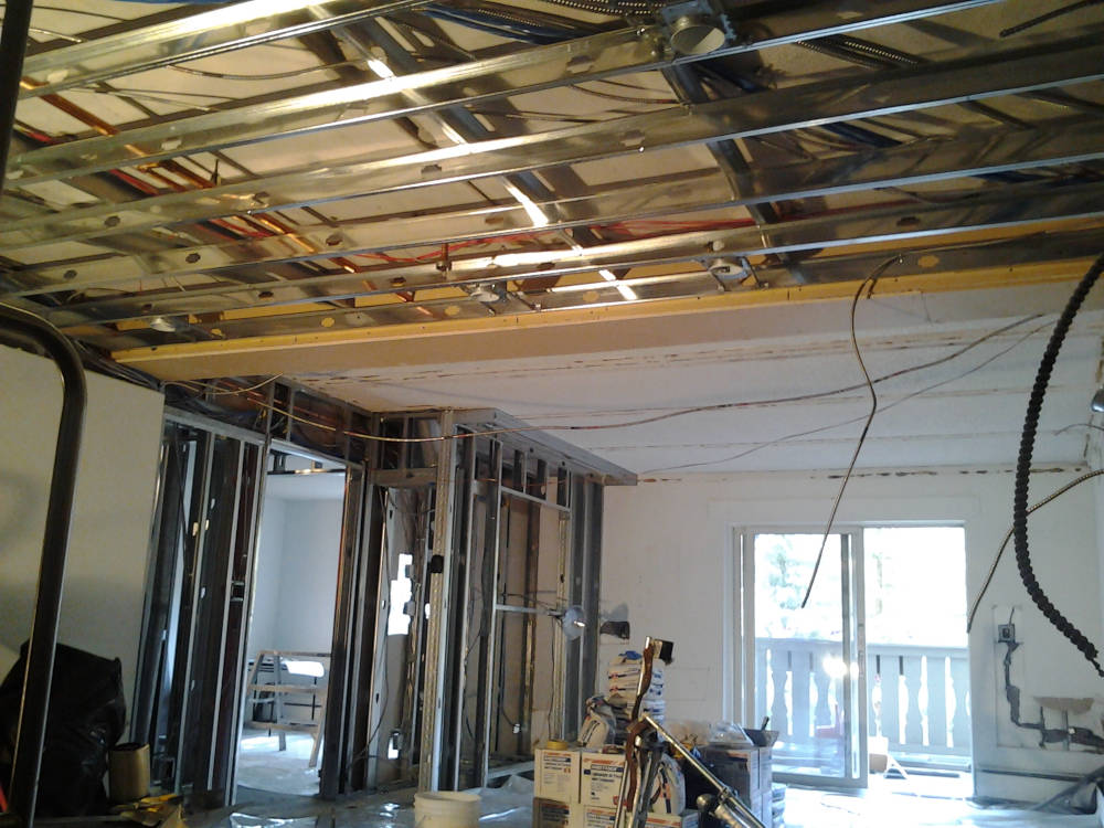 showing a condominium after the steel stud framing and new light installation is done.